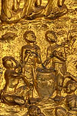 Luang Prabang, Laos - Wat Mai the gilded stucco engravings of the veranda. They narrate the Vessantara Jataka with scenes of everyday life. 